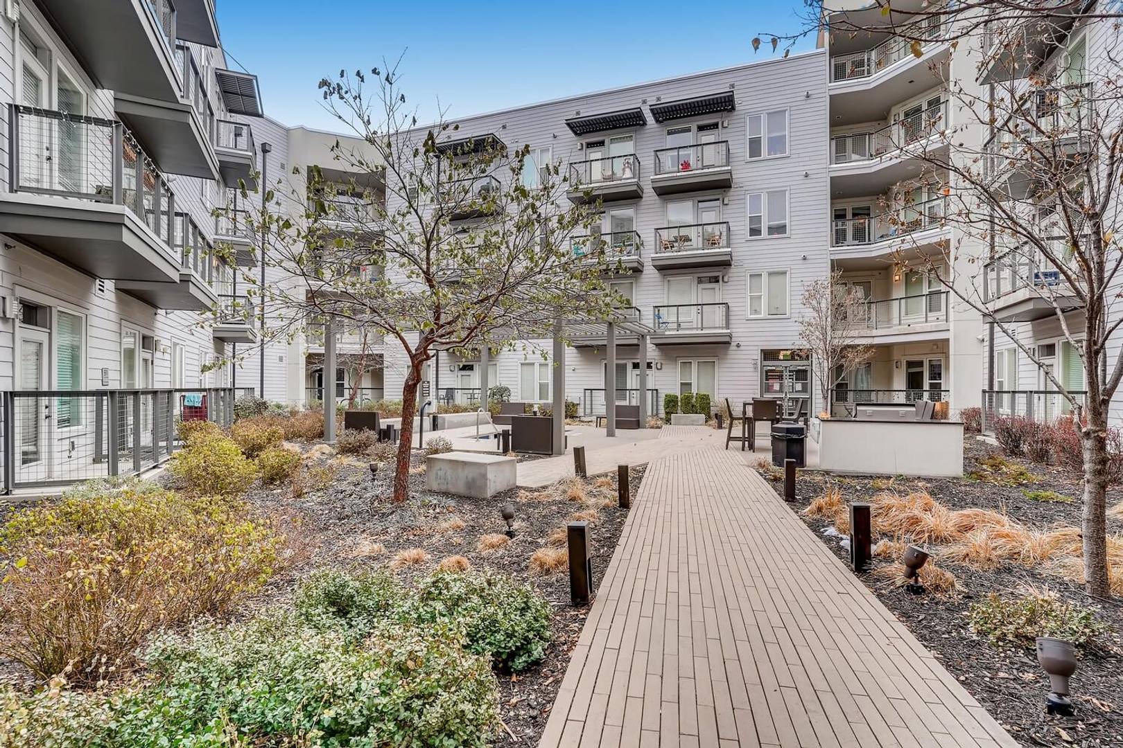 Apartment community courtyard with seating and landscaping