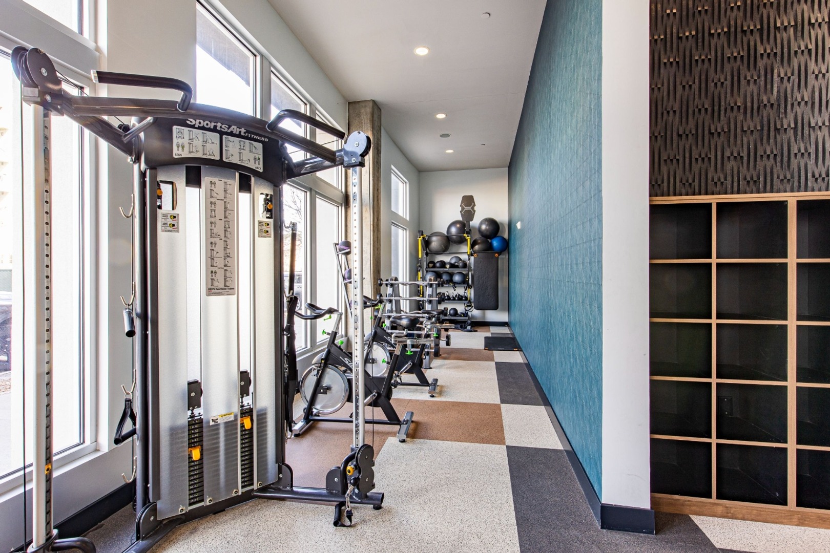 Resident gym featuring treadmills, weights, and machines