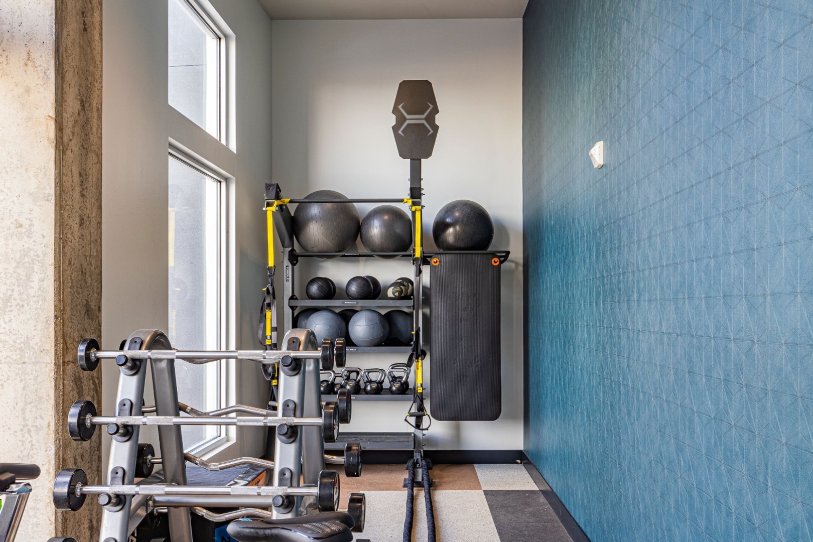 Resident gym featuring treadmills, weights, and machines